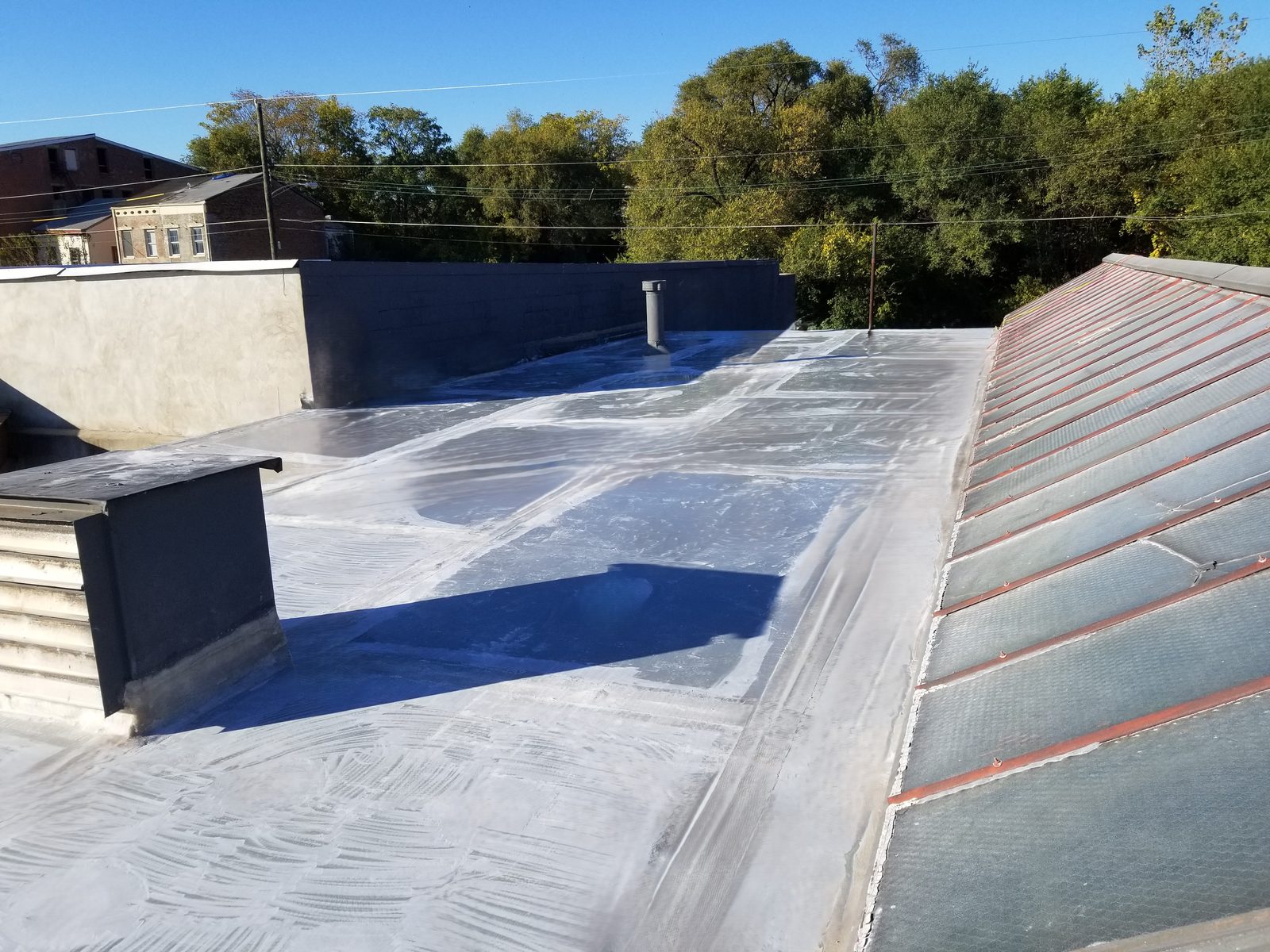 A freshly coated fiberglass roof surface after installation