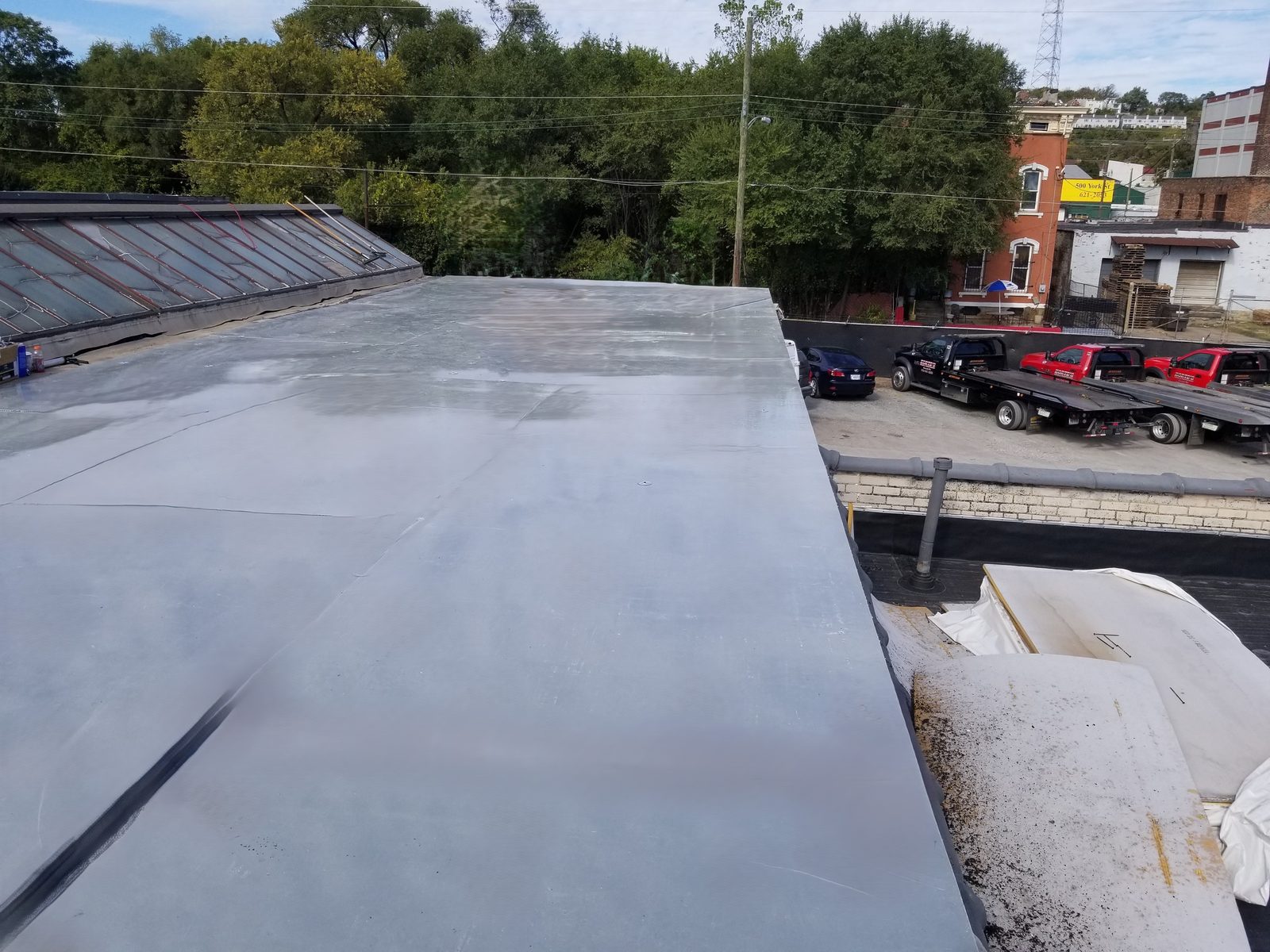 Fiberglass roofing sheets staged on a rooftop, ready for installation